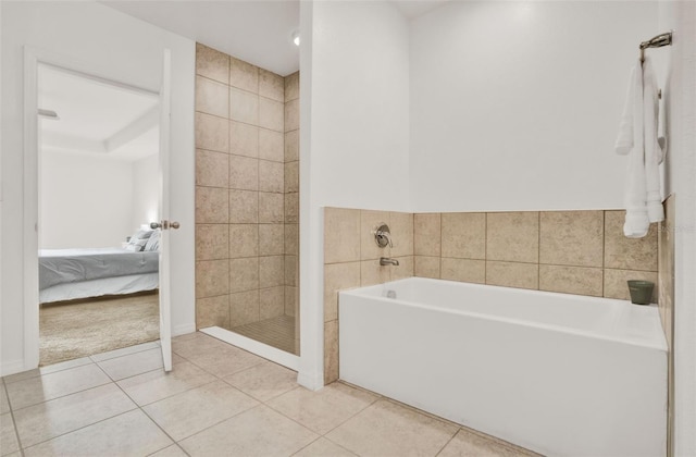 554 Pawnee Ct, Haines City, FL 33844 - bathroom with ensuite bathroom, a garden tub, tile patterned flooring, and a tile shower
