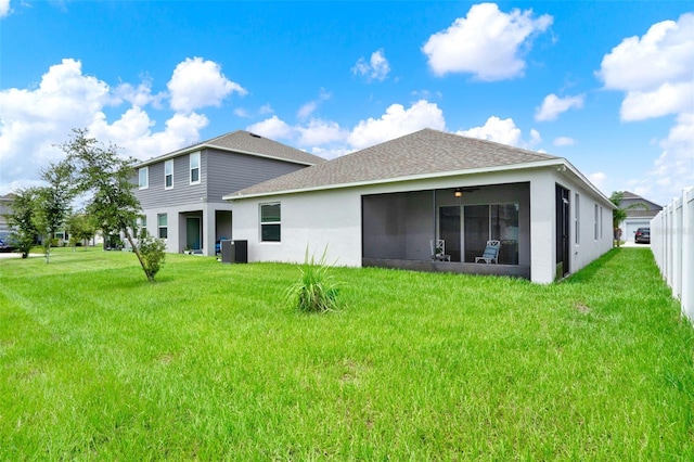 554 Pawnee Ct, Haines City, FL 33844 - back of property featuring a sunroom, roof with shingles, a yard, and stucco siding