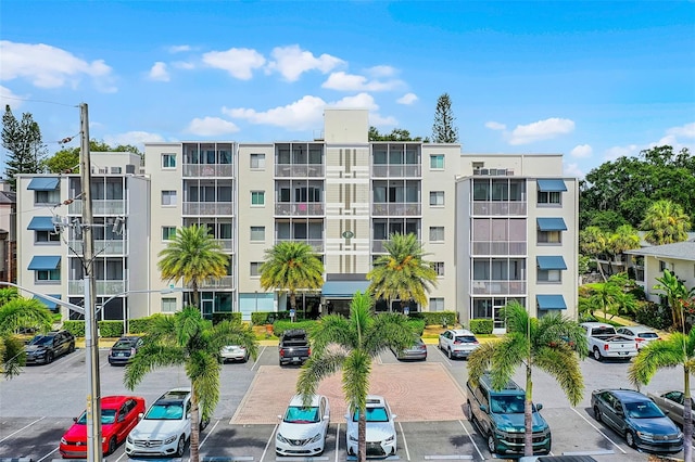 1100 Delaney Ave Unit F407, Orlando, FL 32806 - view of apartment building / complex featuring uncovered parking