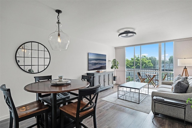1100 Delaney Ave Unit F407, Orlando, FL 32806 - dining space with wood finished floors and floor to ceiling windows