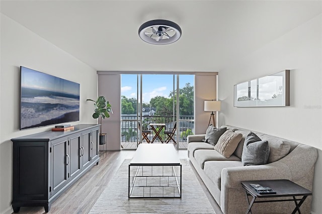 1100 Delaney Ave Unit F407, Orlando, FL 32806 - living room featuring a ceiling fan, light wood-style floors, and floor to ceiling windows