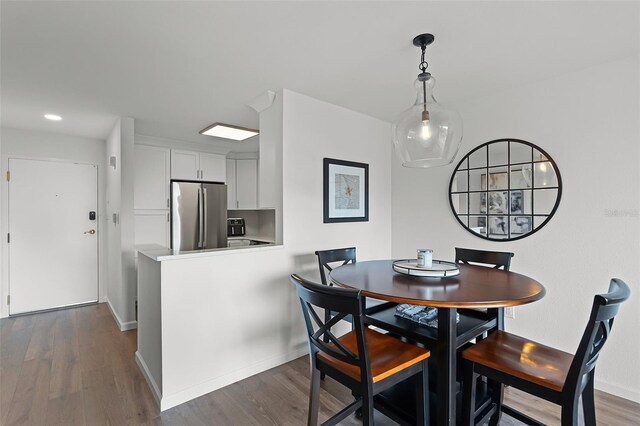 1100 Delaney Ave Unit F407, Orlando, FL 32806 - dining space featuring dark wood finished floors and baseboards