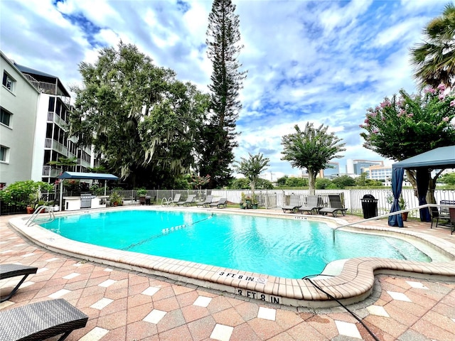 1100 Delaney Ave Unit F407, Orlando, FL 32806 - community pool featuring a gazebo and a patio area