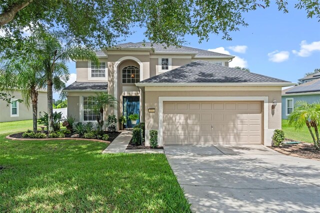 594 Hernando Pl, Clermont, FL 34715 - traditional home with stucco siding, an attached garage, driveway, and a front lawn
