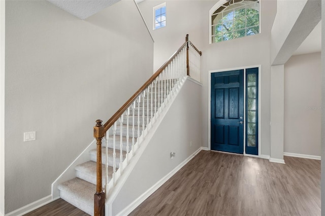 594 Hernando Pl, Clermont, FL 34715 - foyer with wood finished floors, stairway, and a towering ceiling