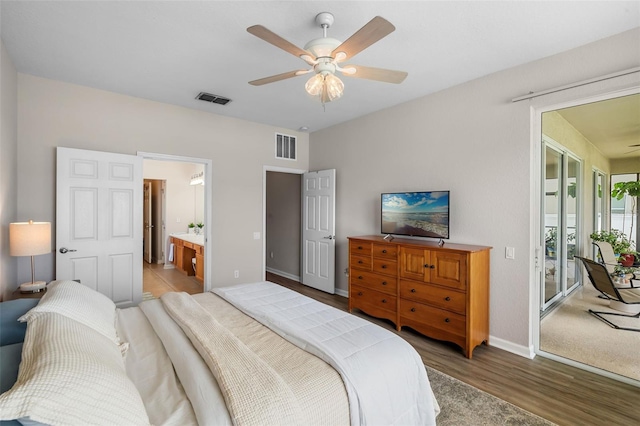 594 Hernando Pl, Clermont, FL 34715 - bedroom featuring access to exterior, wood finished floors, a ceiling fan, and connected bathroom