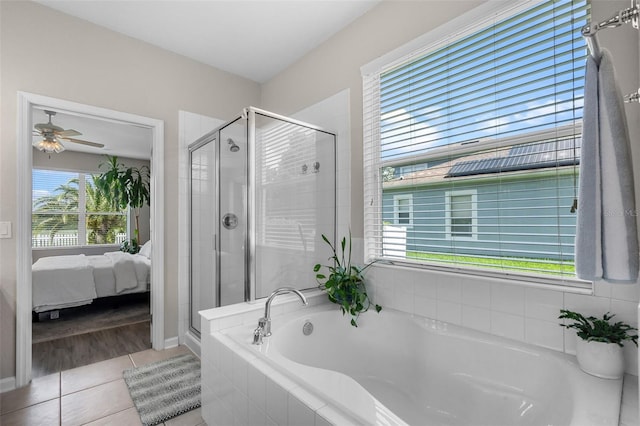 594 Hernando Pl, Clermont, FL 34715 - bathroom with ensuite bath, a stall shower, a bath, tile patterned flooring, and ceiling fan
