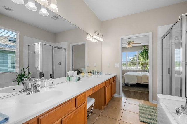 594 Hernando Pl, Clermont, FL 34715 - ensuite bathroom featuring a shower stall, double vanity, tile patterned flooring, and healthy amount of natural light