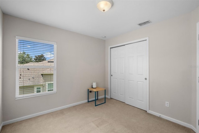 594 Hernando Pl, Clermont, FL 34715 - unfurnished bedroom featuring light colored carpet and a closet