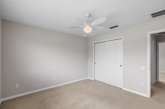 594 Hernando Pl, Clermont, FL 34715 - unfurnished bedroom with light colored carpet, a closet, and a ceiling fan