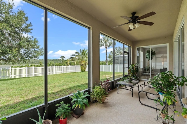594 Hernando Pl, Clermont, FL 34715 - unfurnished sunroom with a ceiling fan and a water view