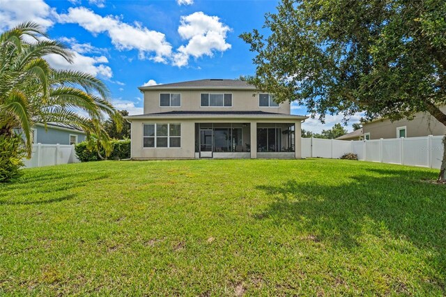 594 Hernando Pl, Clermont, FL 34715 - back of house featuring a sunroom, a fenced backyard, and stucco siding