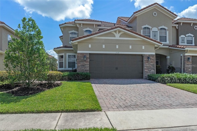 2122 Bent Grass Ave, Ocoee, FL 34761 - view of front of property with stone siding, driveway, a garage, stucco siding, and a front lawn