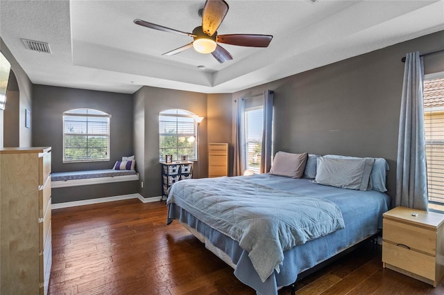 2122 Bent Grass Ave, Ocoee, FL 34761 - bedroom with a tray ceiling, hardwood / wood-style flooring, and a ceiling fan