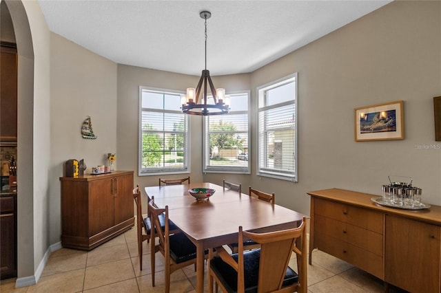 2122 Bent Grass Ave, Ocoee, FL 34761 - dining area with a chandelier, light tile patterned floors, and arched walkways