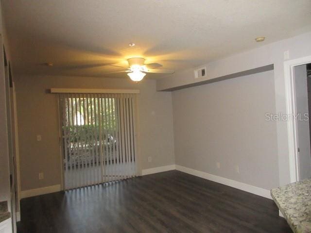 831 Camargo Way Unit 106, Altamonte Springs, FL 32714 - unfurnished room featuring dark wood-style floors, a ceiling fan, and a smoke detector