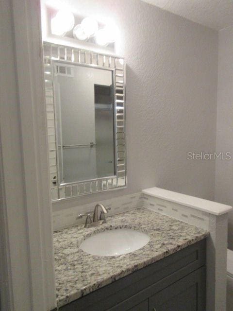 831 Camargo Way Unit 106, Altamonte Springs, FL 32714 - bathroom featuring vanity and a textured wall
