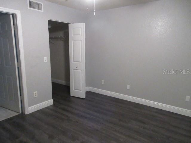 831 Camargo Way Unit 106, Altamonte Springs, FL 32714 - unfurnished bedroom featuring dark wood-style flooring and a closet