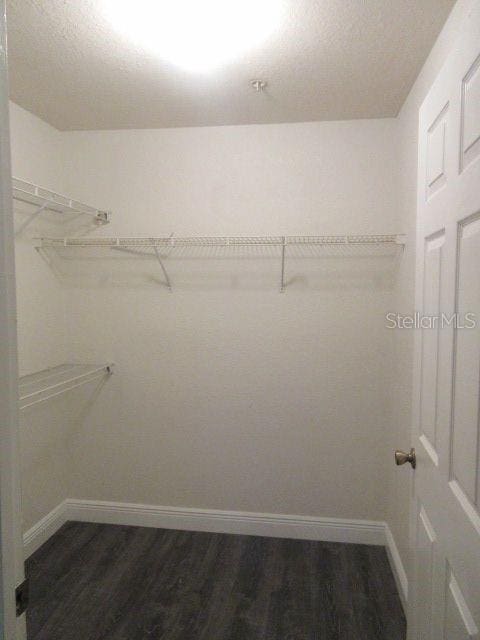 831 Camargo Way Unit 106, Altamonte Springs, FL 32714 - walk in closet featuring dark wood finished floors