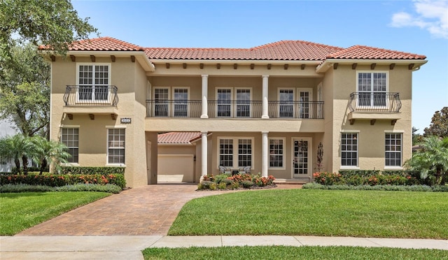 8424 Lake Burden Cir, Windermere, FL 34786 - mediterranean / spanish-style home with a balcony, stucco siding, decorative driveway, and a front yard