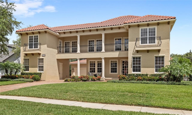 8424 Lake Burden Cir, Windermere, FL 34786 - view of front of house featuring a balcony, stucco siding, a front yard, and a tile roof