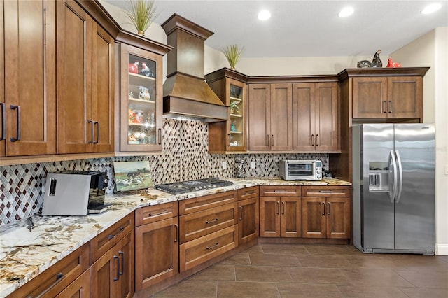 8424 Lake Burden Cir, Windermere, FL 34786 - kitchen with stainless steel appliances, custom range hood, decorative backsplash, light stone counters, and recessed lighting