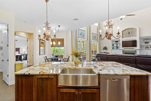 8424 Lake Burden Cir, Windermere, FL 34786 - kitchen with stainless steel dishwasher, a chandelier, open floor plan, pendant lighting, and light stone countertops
