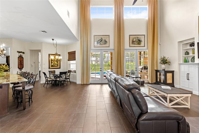 8424 Lake Burden Cir, Windermere, FL 34786 - living area featuring a chandelier, a high ceiling, and french doors