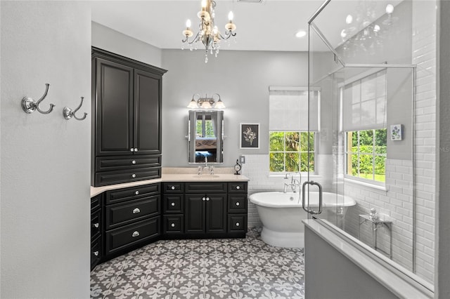 8424 Lake Burden Cir, Windermere, FL 34786 - ensuite bathroom featuring vanity, a chandelier, a freestanding tub, a shower stall, and wainscoting