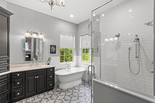 8424 Lake Burden Cir, Windermere, FL 34786 - bathroom featuring a shower stall, a soaking tub, vanity, tile walls, and a wainscoted wall