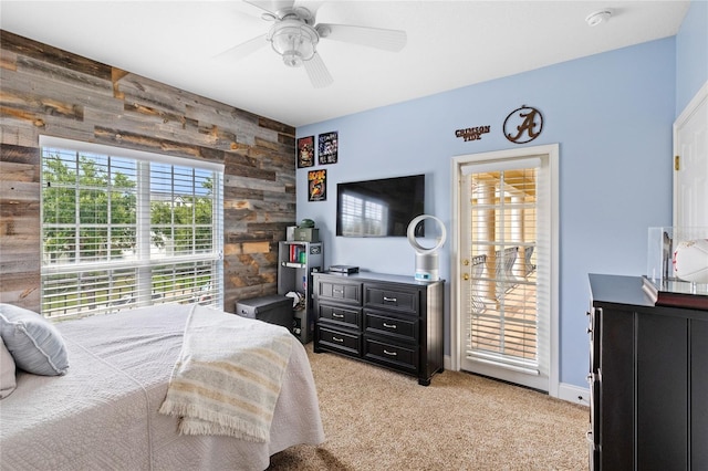 8424 Lake Burden Cir, Windermere, FL 34786 - bedroom featuring wooden walls, light colored carpet, an accent wall, and a ceiling fan