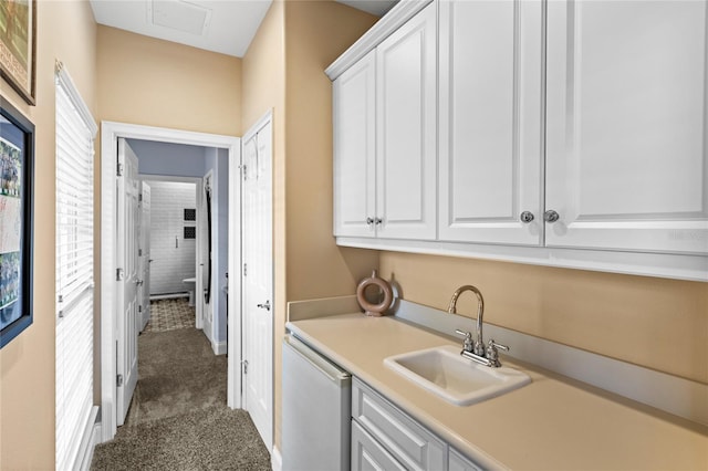 8424 Lake Burden Cir, Windermere, FL 34786 - laundry room featuring a sink and dark colored carpet
