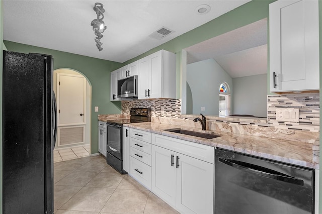 851 Bates Ct, Casselberry, FL 32707 - kitchen featuring black appliances, light tile patterned flooring, white cabinets, and decorative backsplash
