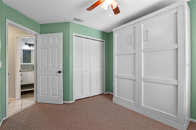 851 Bates Ct, Casselberry, FL 32707 - unfurnished bedroom featuring carpet floors, a textured ceiling, a closet, and ceiling fan