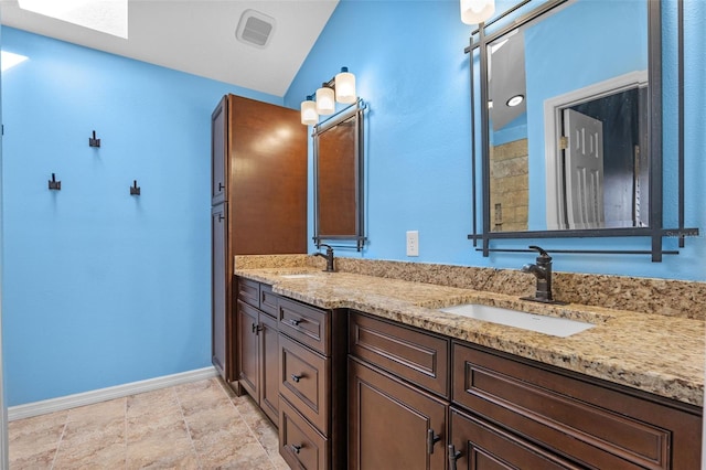 851 Bates Ct, Casselberry, FL 32707 - bathroom with double vanity, vaulted ceiling, and a skylight