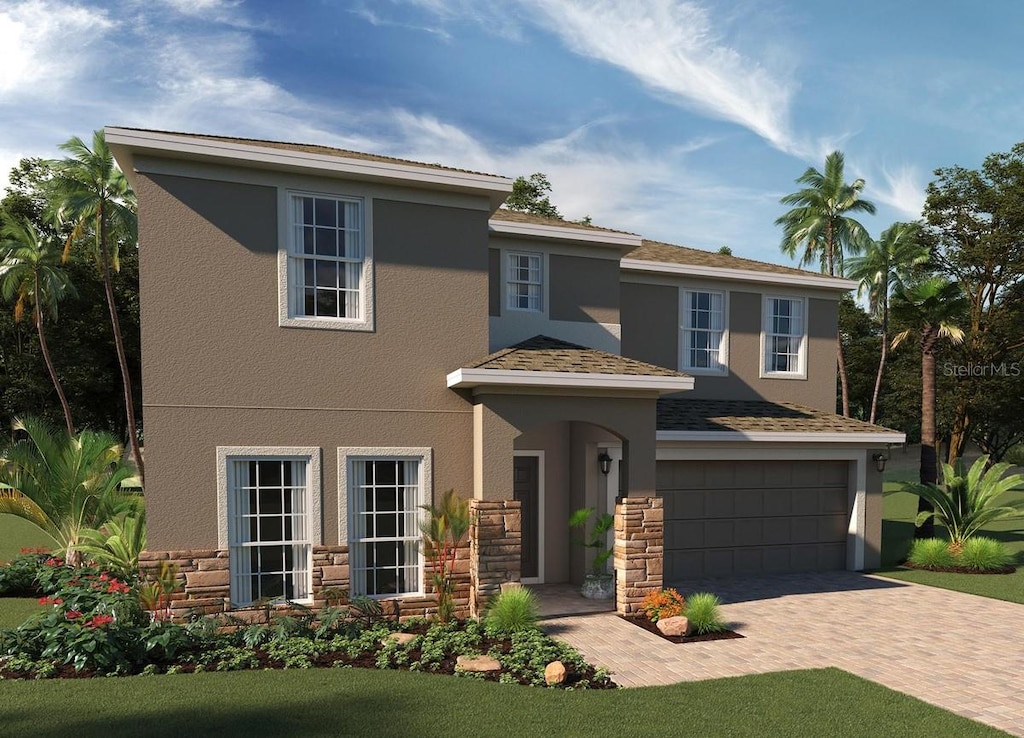 4005 Serene Water Ave, Eustis, FL 32736 - view of front of house with stucco siding, a garage, decorative driveway, and stone siding