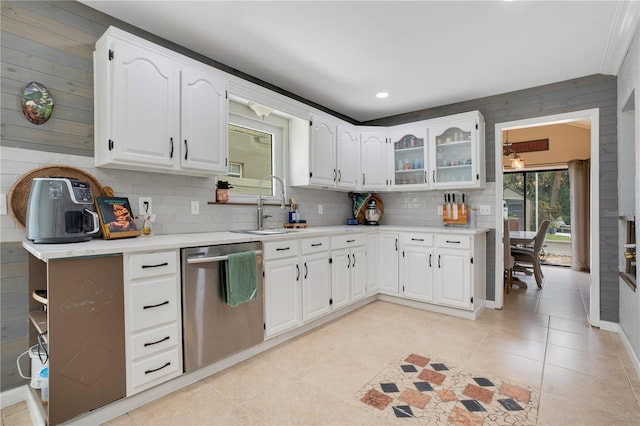 1035 Paladin Ct, Orlando, FL 32812 - kitchen with stainless steel dishwasher, tasteful backsplash, white cabinets, light countertops, and glass insert cabinets