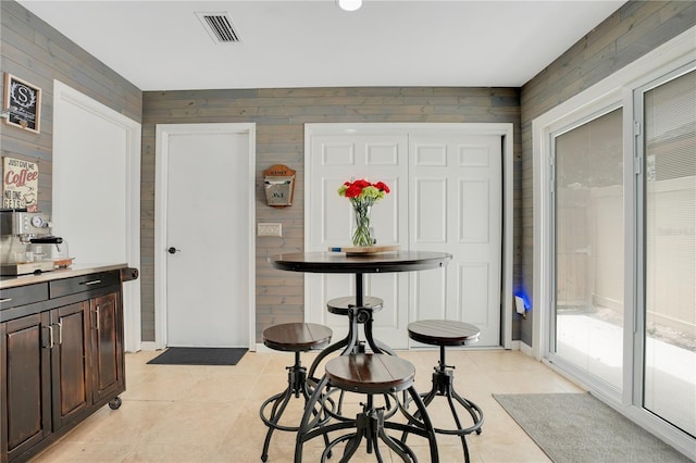 1035 Paladin Ct, Orlando, FL 32812 - dining space with wooden walls and light tile patterned floors