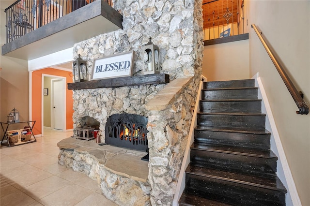 1035 Paladin Ct, Orlando, FL 32812 - stairs featuring tile patterned flooring, a fireplace, and a towering ceiling