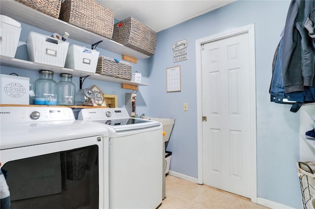1035 Paladin Ct, Orlando, FL 32812 - laundry area featuring washing machine and dryer and light tile patterned floors