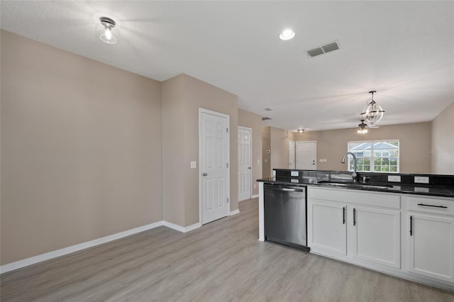 1030 Bending Oak Trl, Winter Garden, FL 34787 - kitchen with stainless steel dishwasher, light wood-style floors, white cabinetry, a chandelier, and hanging light fixtures