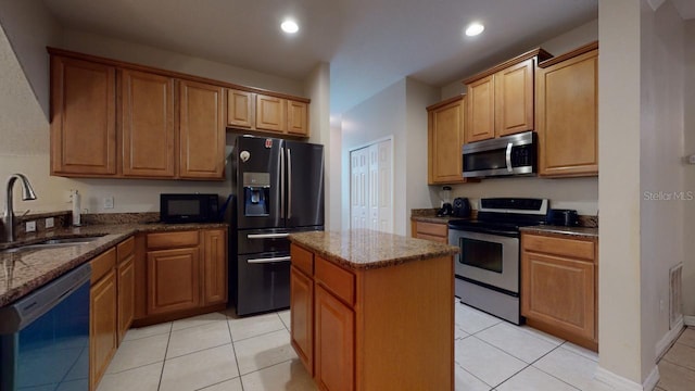 3552 Macauley Ct, Ocoee, FL 34761 - kitchen featuring appliances with stainless steel finishes, a center island, dark stone counters, light tile patterned floors, and recessed lighting