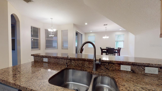 3552 Macauley Ct, Ocoee, FL 34761 - kitchen with a chandelier, dark stone countertops, decorative light fixtures, recessed lighting, and a textured ceiling