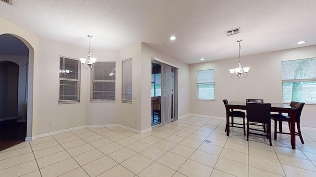 3552 Macauley Ct, Ocoee, FL 34761 - dining area featuring a chandelier, recessed lighting, arched walkways, light tile patterned floors, and a textured ceiling