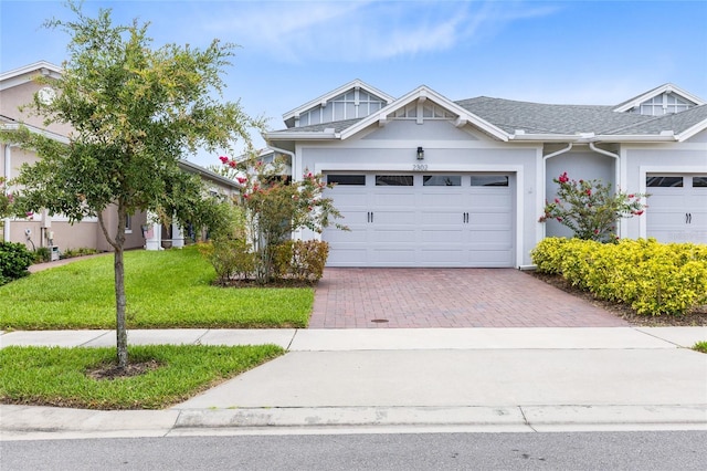 2302 Datura Loop, Saint Cloud, FL 34772 - view of front of house featuring decorative driveway, an attached garage, a front yard, and stucco siding