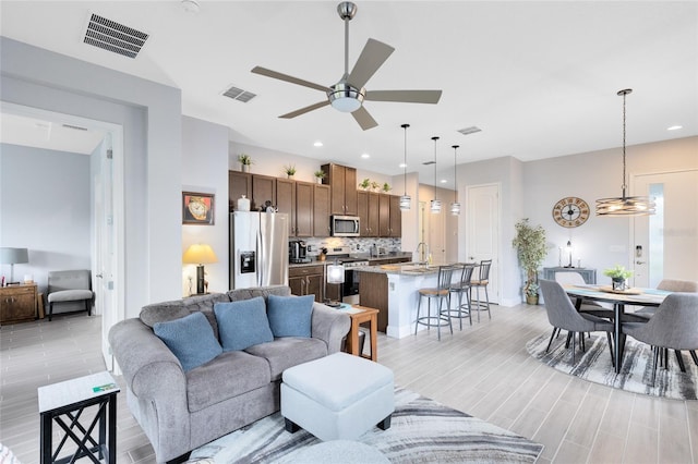 2302 Datura Loop, Saint Cloud, FL 34772 - living room featuring ceiling fan, light wood-style floors, and recessed lighting