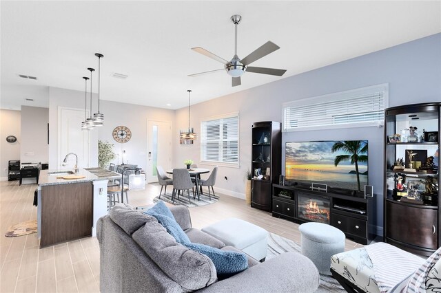 2302 Datura Loop, Saint Cloud, FL 34772 - living room featuring a ceiling fan and light wood-type flooring
