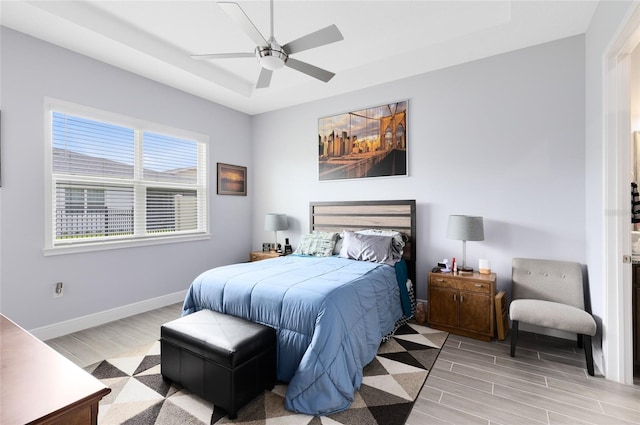 2302 Datura Loop, Saint Cloud, FL 34772 - bedroom featuring a raised ceiling, wood finished floors, and ceiling fan