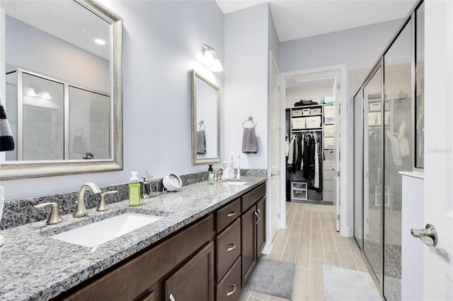 2302 Datura Loop, Saint Cloud, FL 34772 - bathroom featuring double vanity, a stall shower, and a spacious closet