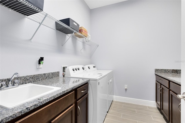 2302 Datura Loop, Saint Cloud, FL 34772 - laundry area with independent washer and dryer, wood finish floors, and cabinet space